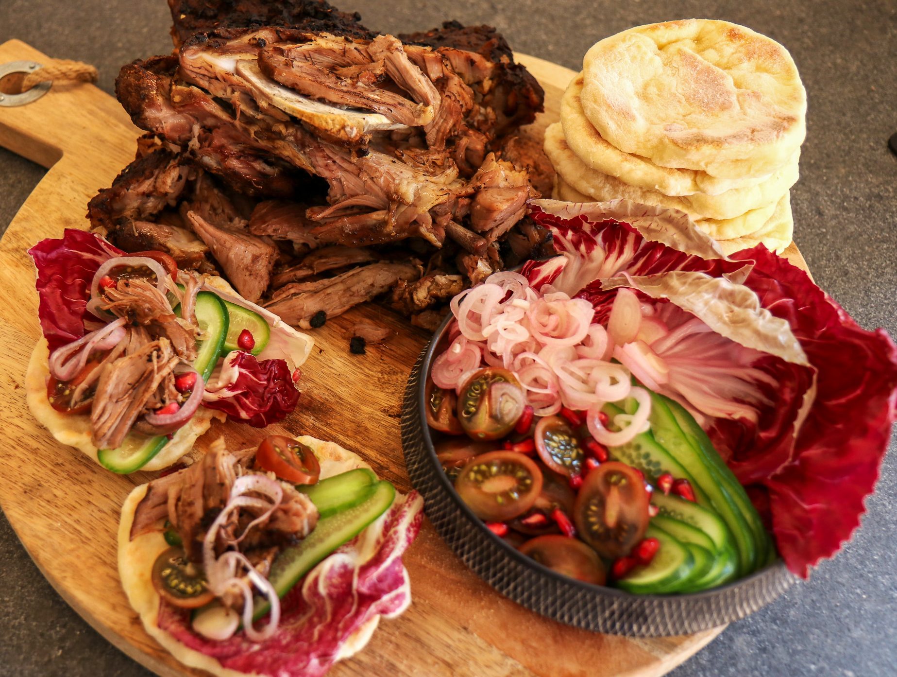 Photo of Spiced Slow Roasted Dairy Capretto Shoulder With Black Garlic and Yoghurt Flat Breads